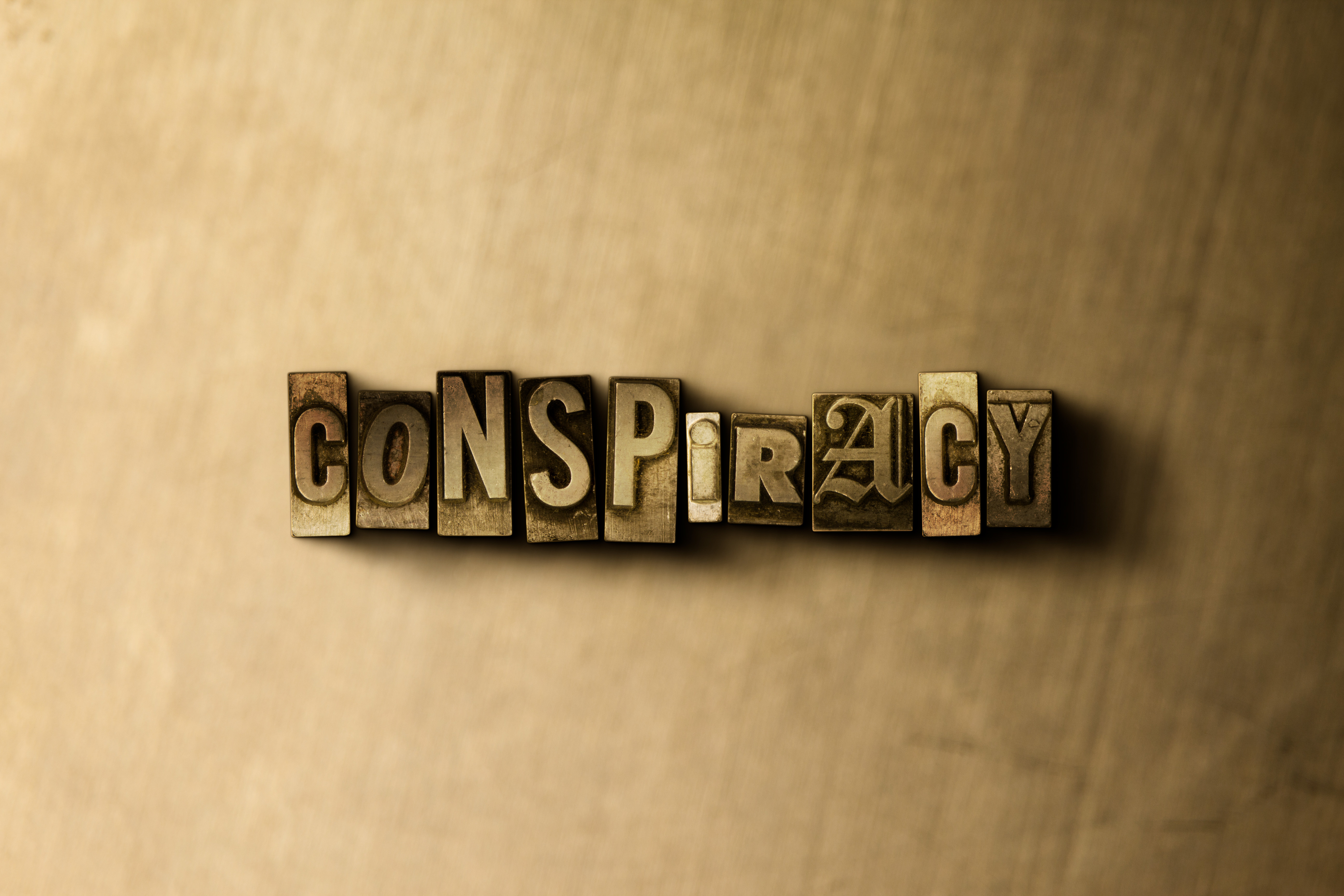 Conspiracy letters on wooden background image.jpeg