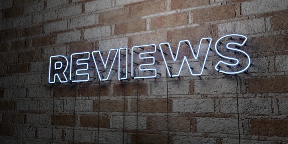 REVIEWS - Glowing Neon Sign on stonework wall